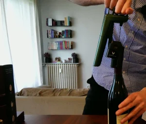 Coravin Timeless Six+ nasazený na hrdle láhve, jehla prochází zátkou